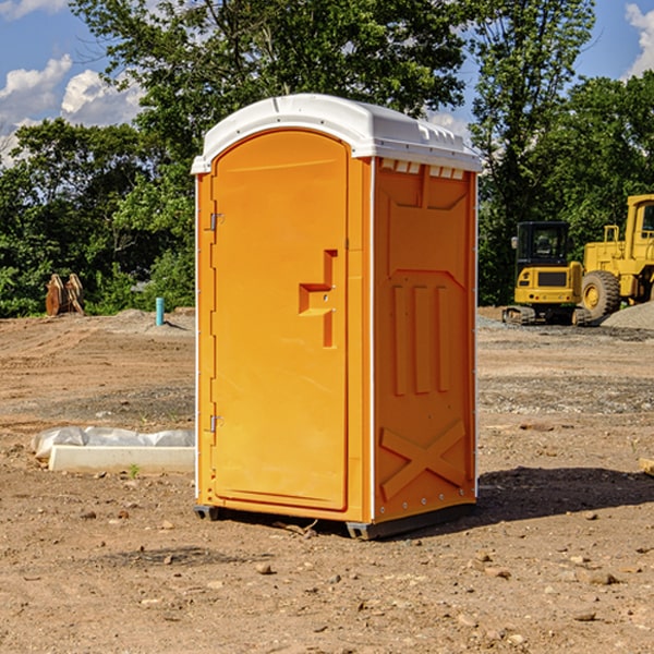 what is the cost difference between standard and deluxe portable restroom rentals in Roach